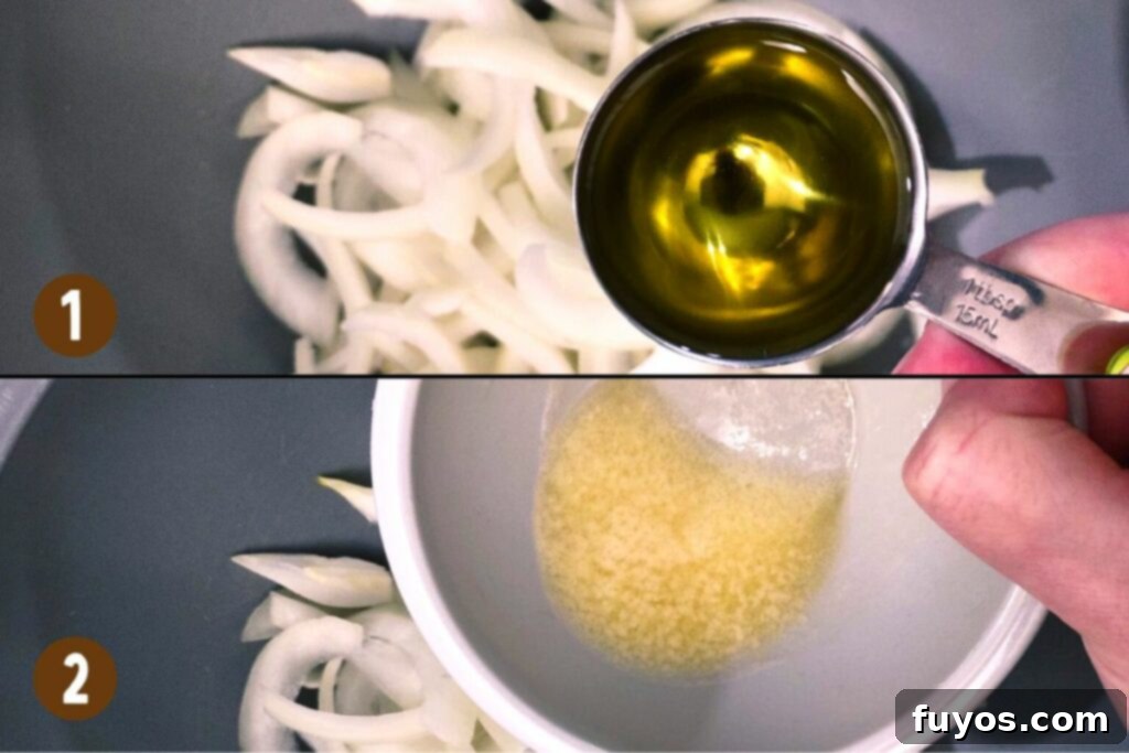 Air Fryer Caramelized Onions Made Easy 6 Separated onion slices being tossed with olive oil and melted butter in a large mixing bowl