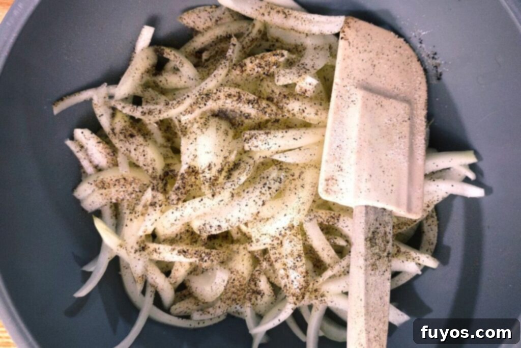 Air Fryer Caramelized Onions Made Easy 7 Onion slices seasoned with salt and pepper, ready for air frying