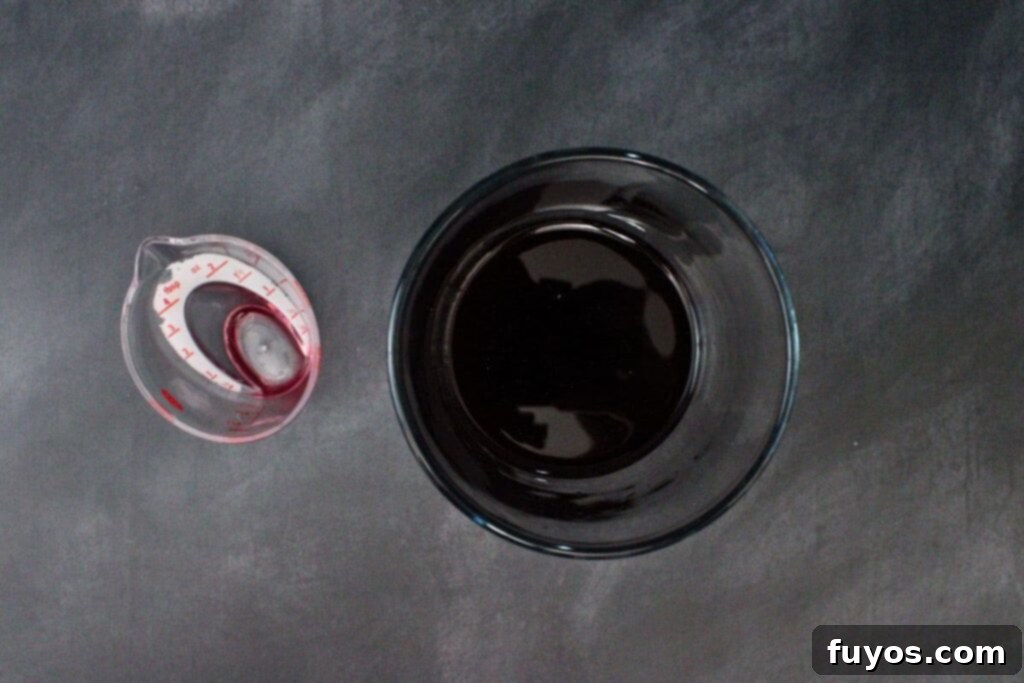 Black Magic Martini: Halloween's Darkest Spell 5 add black martini ingredients to cocktail shaker
