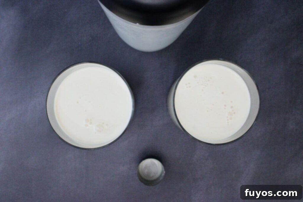 Screaming Ghost Cocktail The Perfect Halloween Potion 6 shake and strain streaming ghost drink into lowball glasses