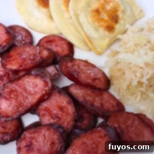 Air fryer kielbasa slices perfectly browned and tender, ready to serve in the air fryer basket