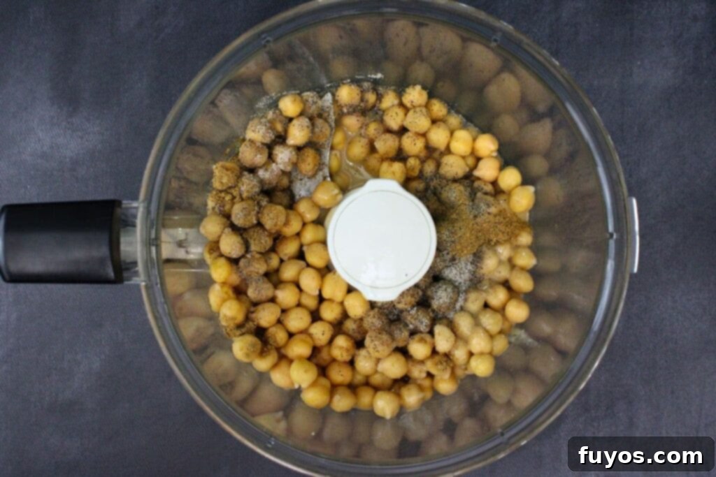 Air Fryer Roasted Beet Hummus 7 add chickpeas, tahini, garlic, lemon juice, salt, pepper, and cumin to food processor