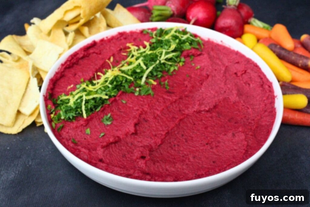 Air Fryer Roasted Beet Hummus 10 bowl of air fryer roasted beet hummus surrounded by pita chips and fresh vegetables