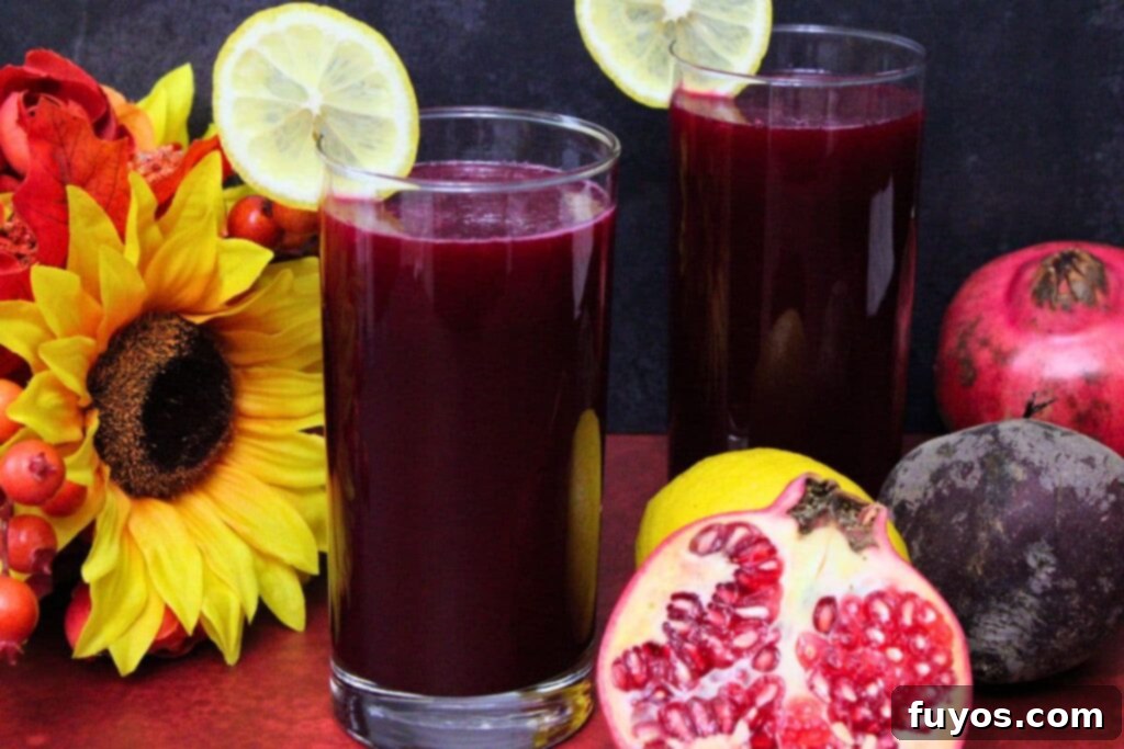 Easy Three Ingredient Beetroot Pomegranate Lemonade 3 two glasses of beetroot pomegranate lemonade with lemon slices