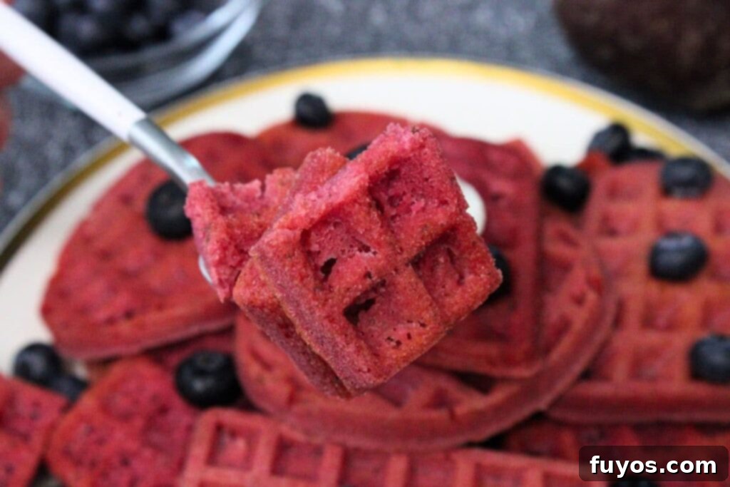 Roasted Beet Waffles An Air Fryer Breakfast Delight 3 holding up a fork with pieces of beetroot waffles
