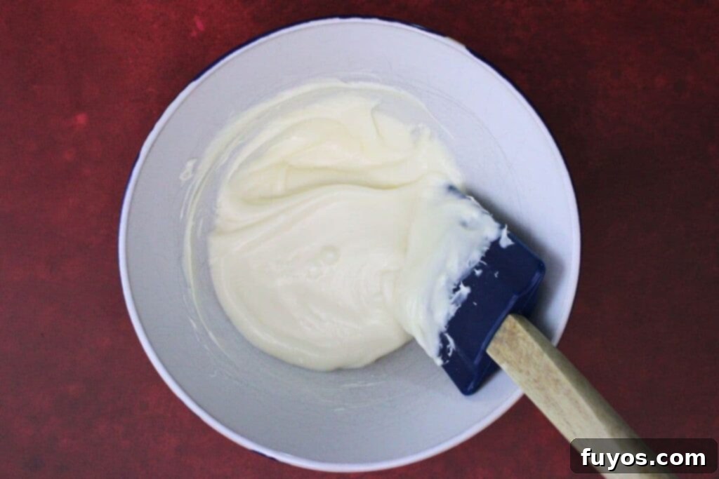 add white chocolate chips to microwave safe bowl and melt