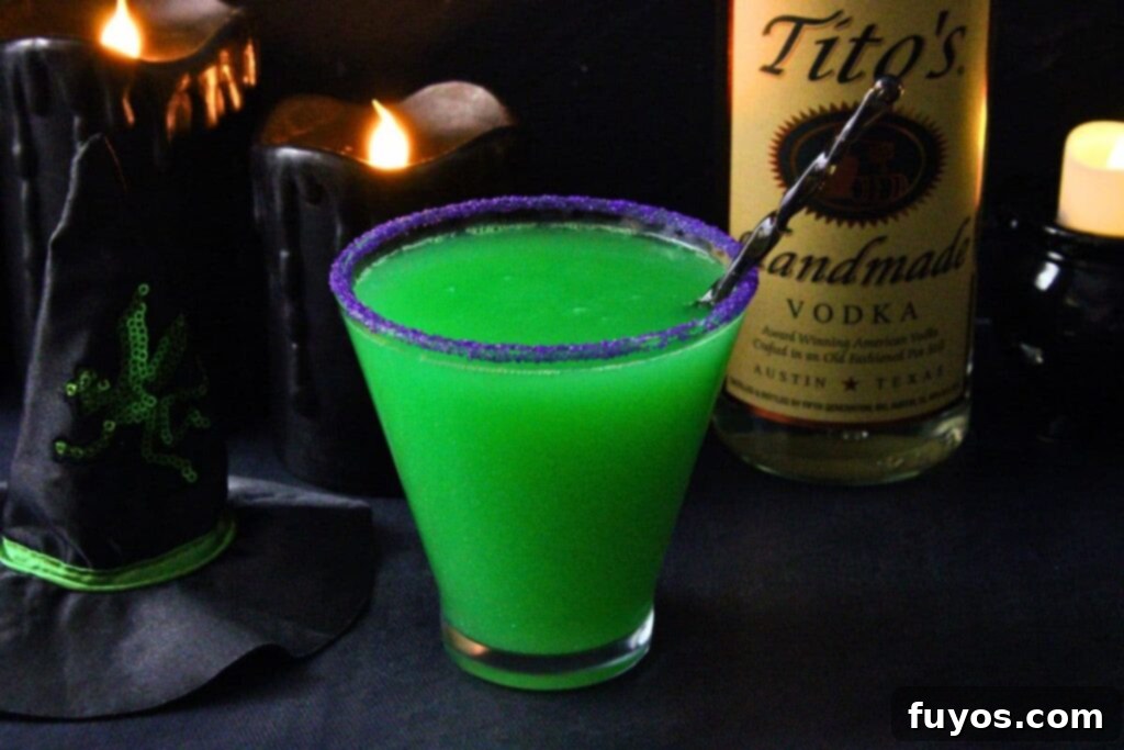 Wicked Witch Vodka Cocktail 3 Wicked Witch Cocktail in a martini glass, beside a vodka bottle and a mini witch hat