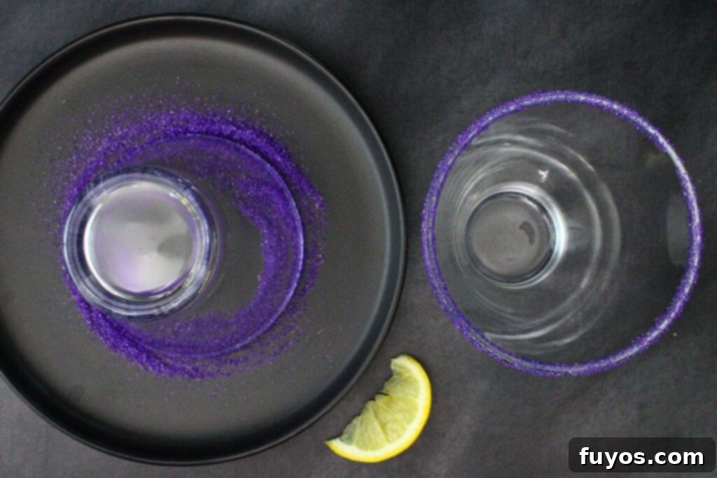 Wicked Witch Vodka Cocktail 5 Rimming a martini glass with purple sanding sugar for the Wicked Witch Cocktail