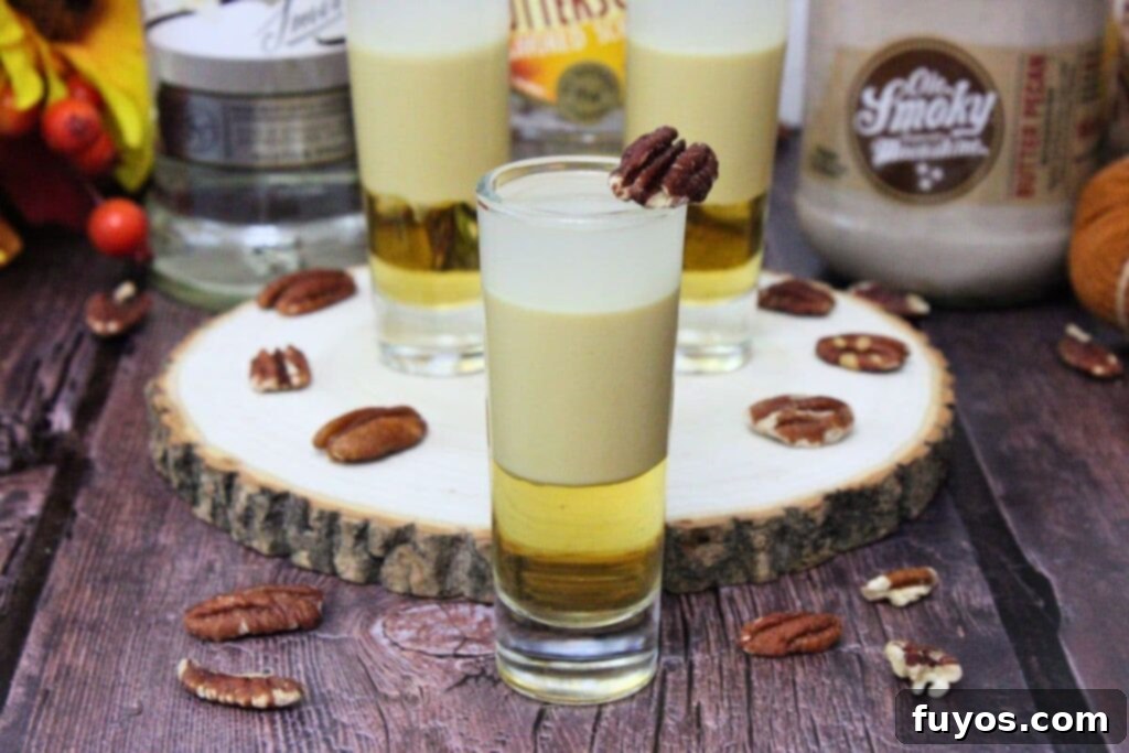 closeup of pecan pie shot with additional shooters in the background on a wooden stump