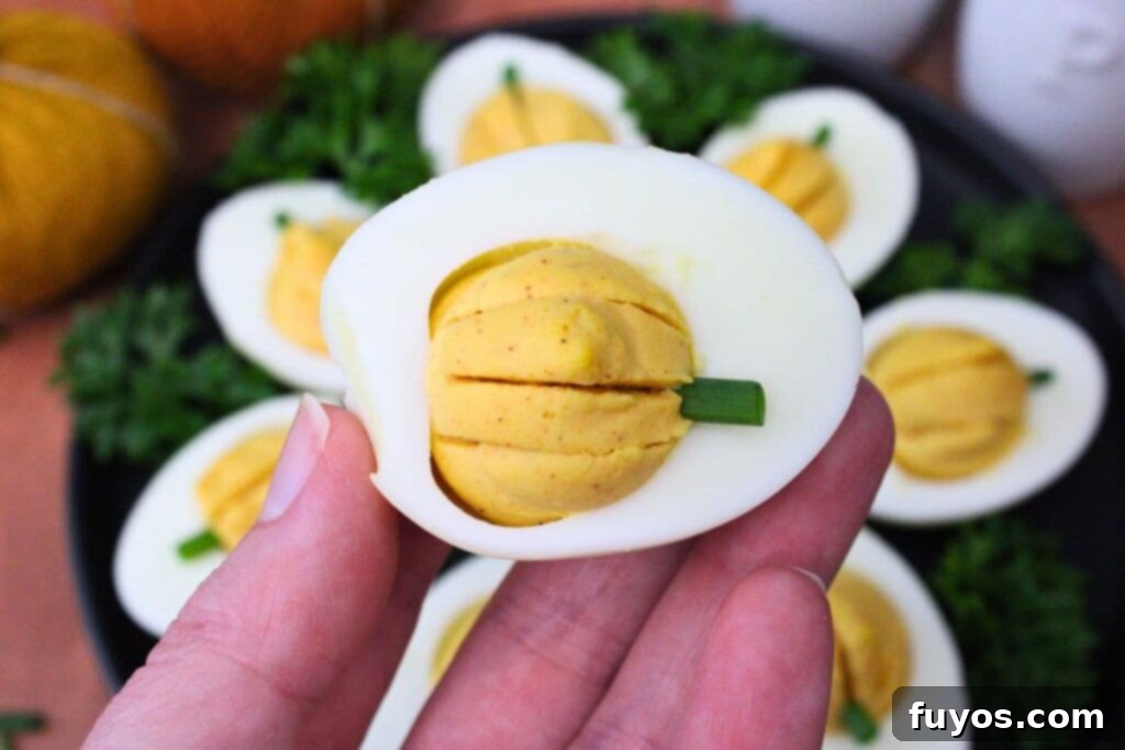 holding up an air fryer pumpkin deviled egg
