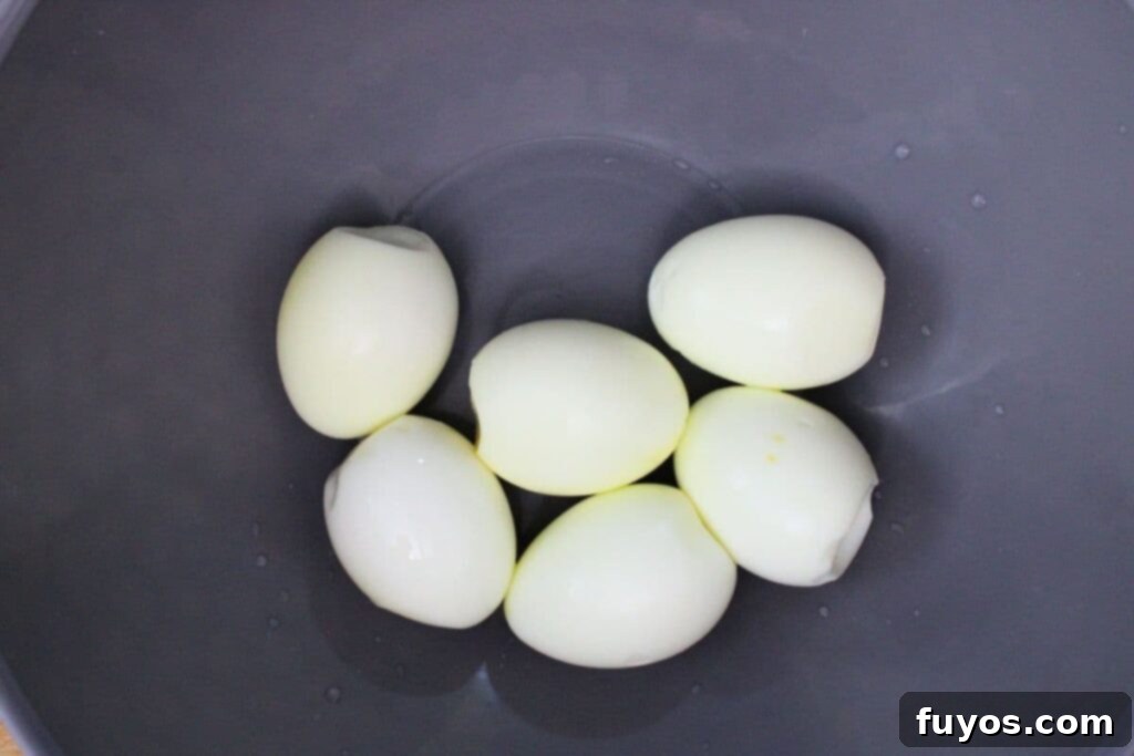 carefully peel hard boiled eggs