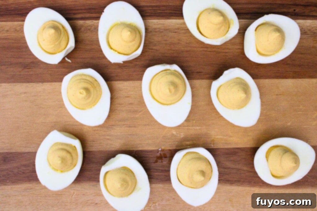 evenly pipe egg filling back into hard boiled egg whites