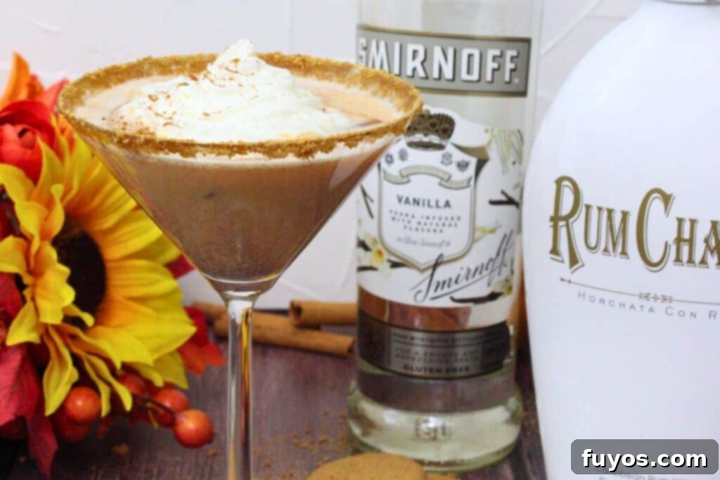 closeup of pumpkin pie martini in front of vanilla vodka and rumchata bottle