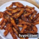 Crispy air fryer butternut squash fries cooked perfectly, ready to be enjoyed as a healthy meal.