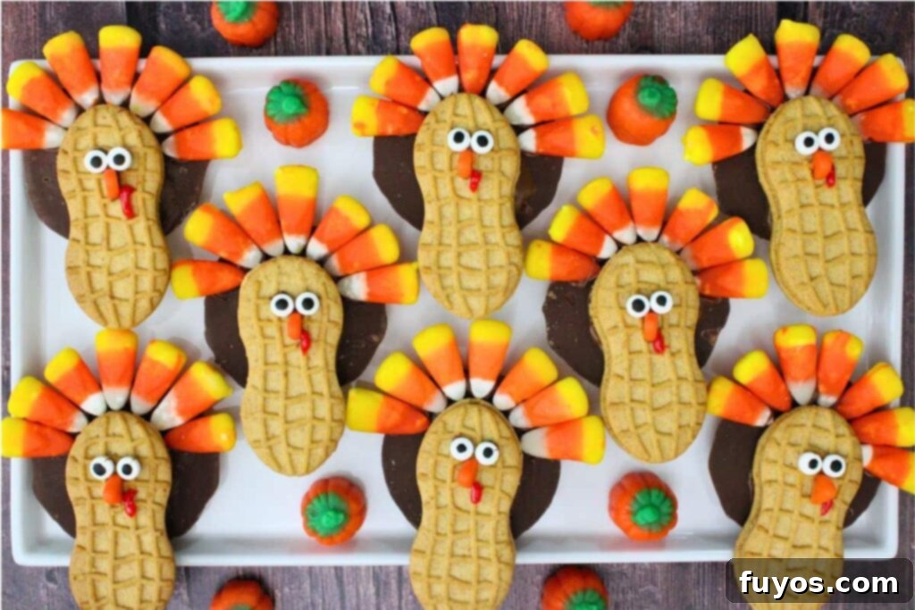overhead view of several nutter butter turkey cookies on a square plate with candy corn