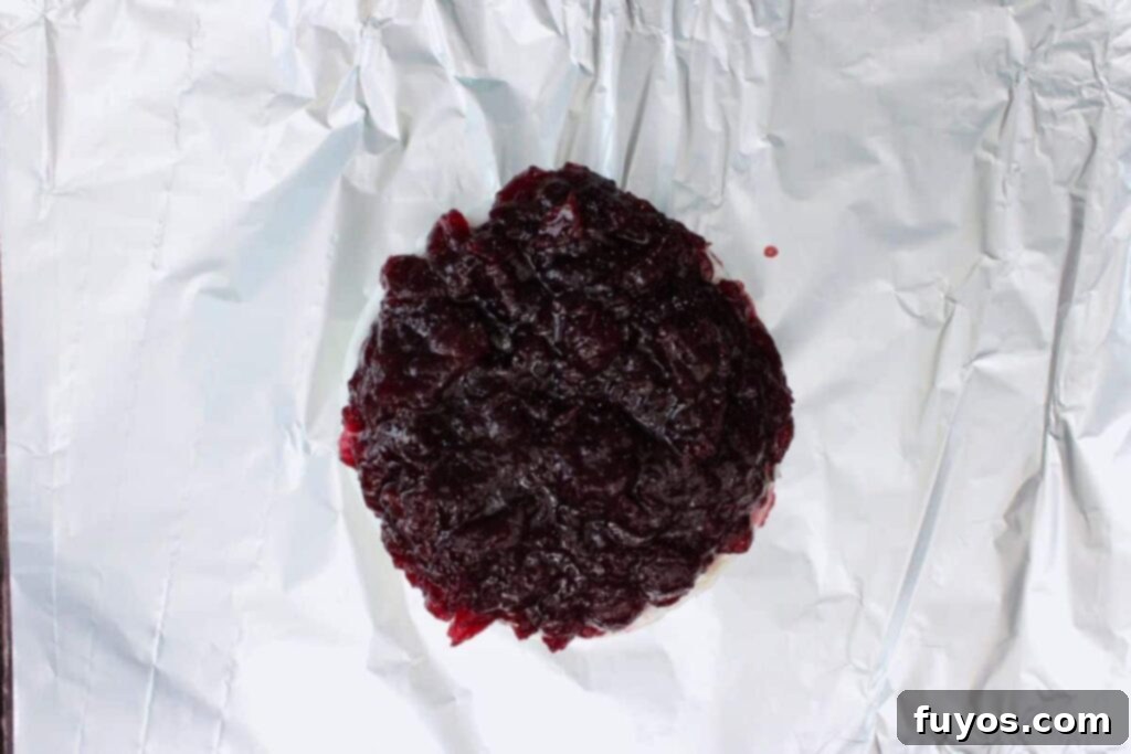 Air Fryer Cranberry Walnut Baked Brie 6 spread cranberry sauce evenly on top of brie cheese