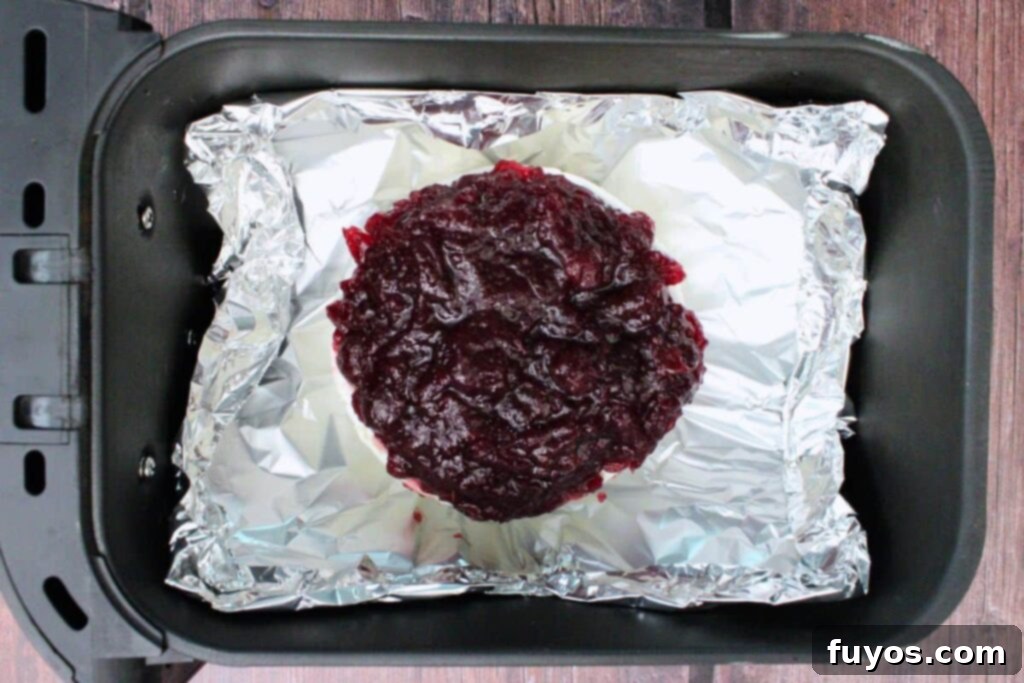 Air Fryer Cranberry Walnut Baked Brie 7 place foil with brie on top in air fryer basket to cook