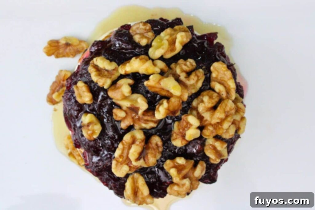 Air Fryer Cranberry Walnut Baked Brie 9 drizzle maple syrup and toasted walnuts on top of baked brie