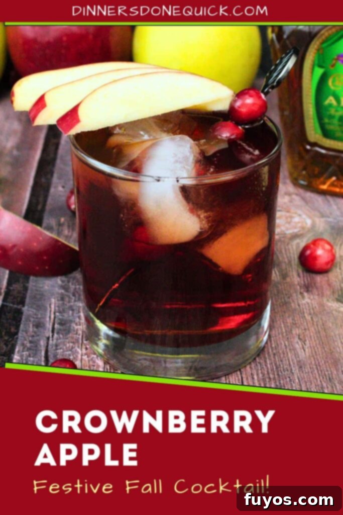 Crownberry Apple Two Ingredient Autumn Delight 12 A tall, vertically oriented image of a Crownberry Apple cocktail with apple slices, suitable for Pinterest sharing.