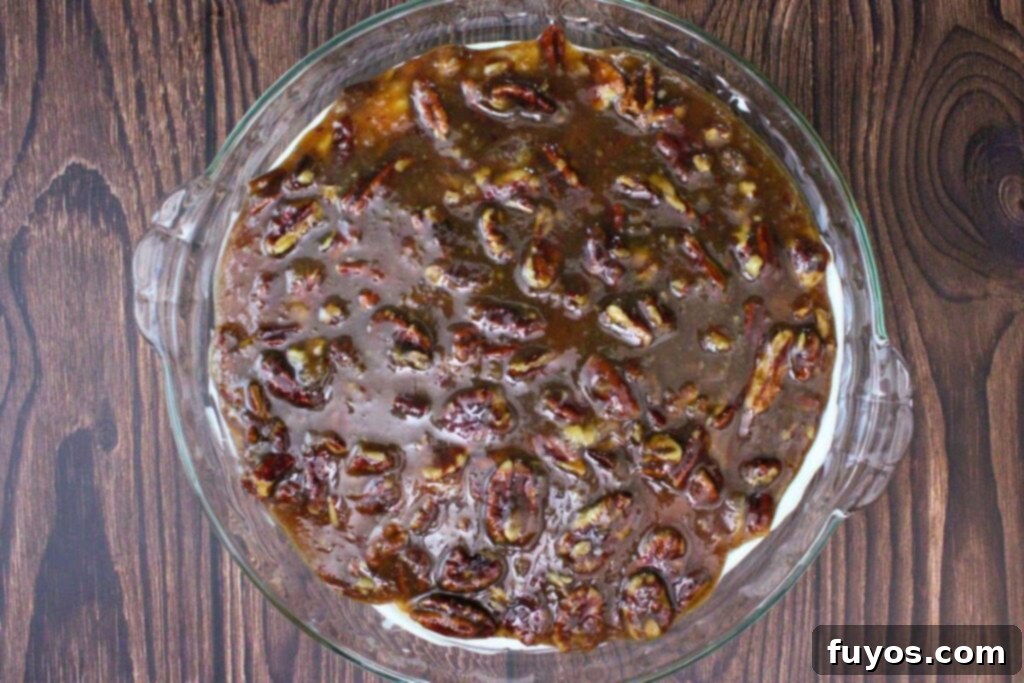pour cooled pecan topping over cream cheese mixture