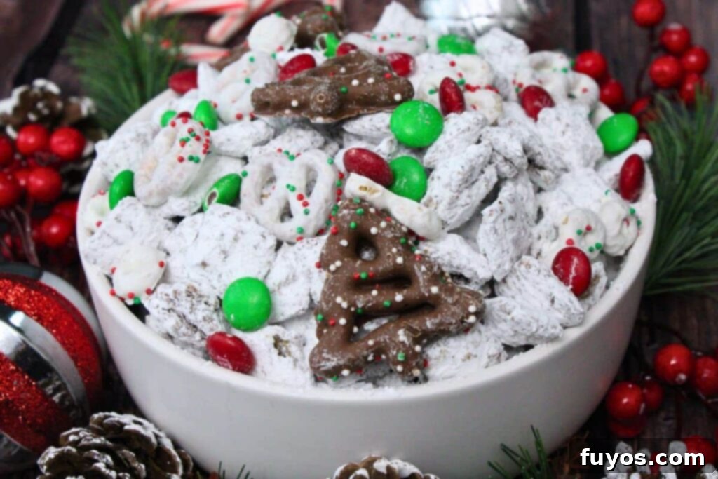 Easy No Bake Christmas Puppy Chow 12 christmas puppy chow in a white bowl surrounded by christmas decorations