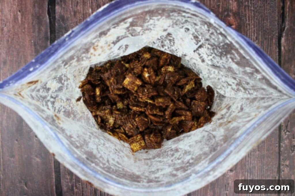 Easy No Bake Christmas Puppy Chow 9 fill ziploc bag with powdered sugar and add coated chex
