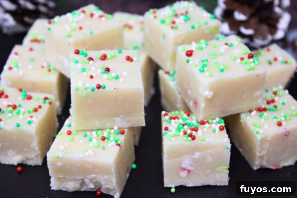 Easy Microwave Christmas Sugar Cookie Fudge Treat 10 Closeup of perfectly stacked sugar cookie fudge squares on a black plate