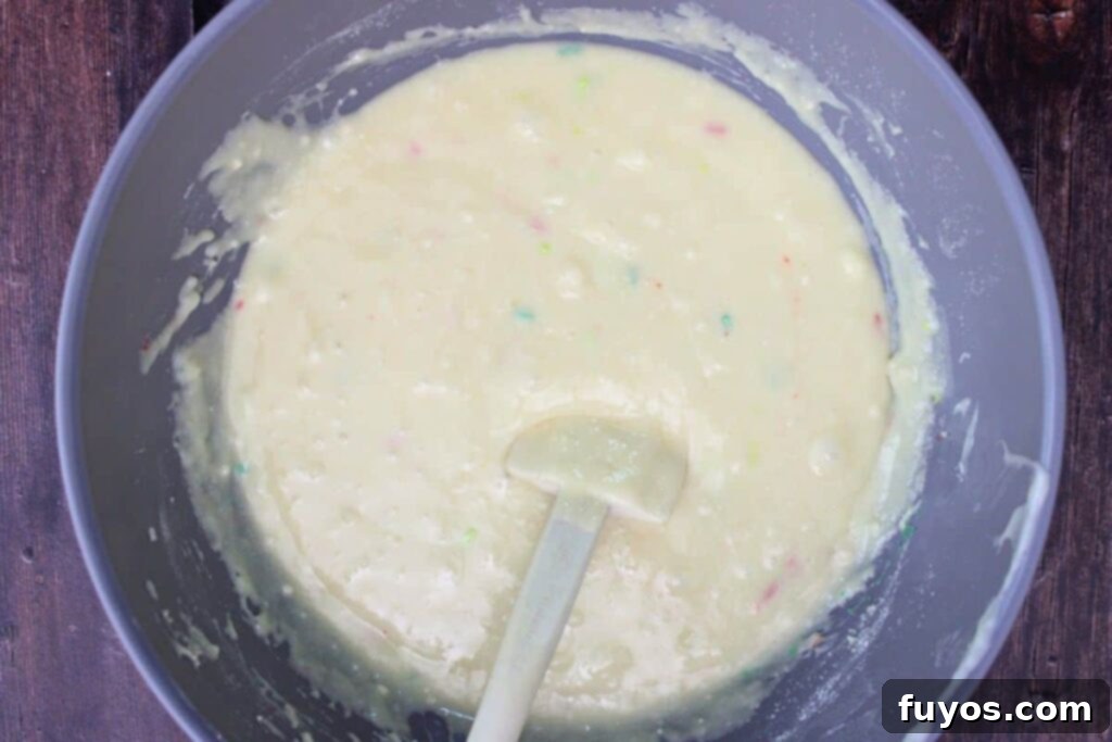 Easy Microwave Christmas Sugar Cookie Fudge Treat 7 Mixing sugar cookie mix and vanilla into the fudge base