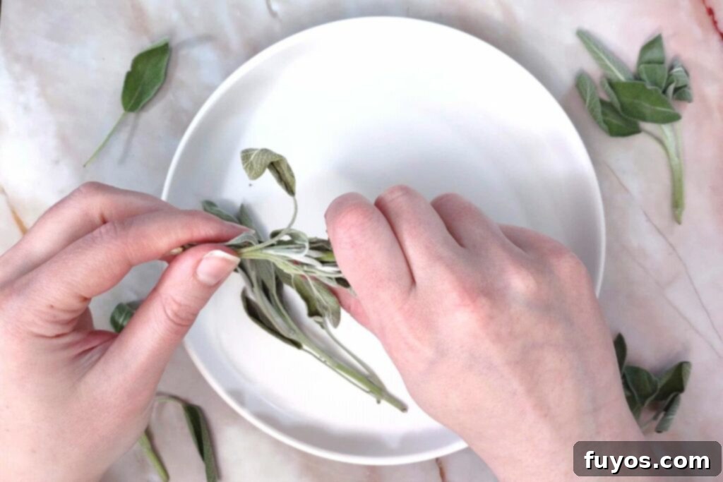remove air fryer dried sage leaves by squeezing with one hand