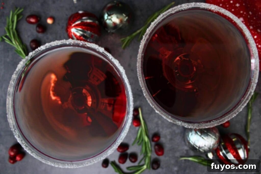 Santa Clausmopolitan Your Ultimate Holiday Drink 8 overhead view of two santa clausmopolitan drinks with sugar rims