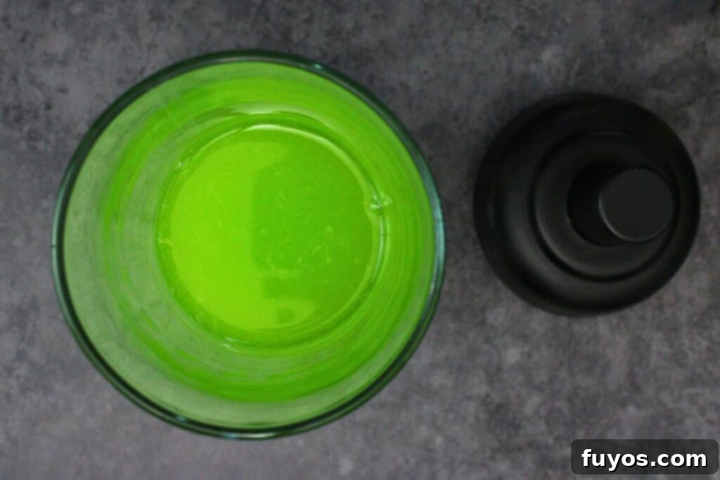 add vodka, midori, lemon juice, and orange juice to cocktail shaker