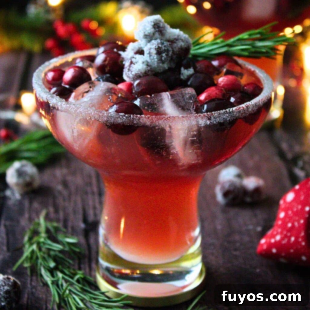 Frosted Mistletoe Margarita Christmas Cocktail 2 Mistletoe Margarita with frosted rim and sugared cranberries, perfect for holidays