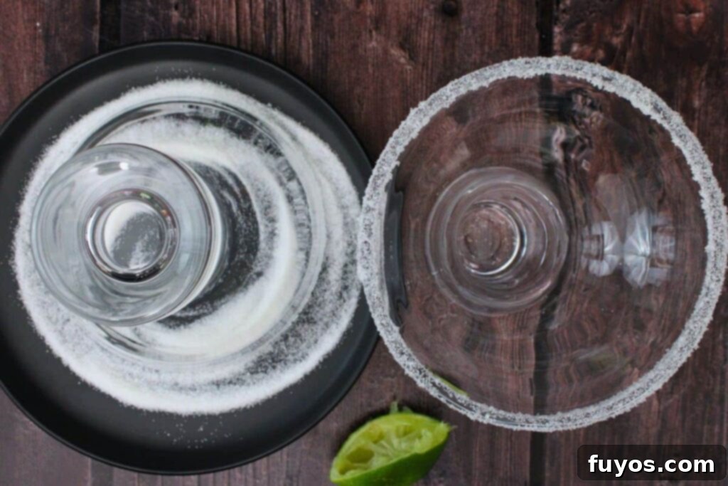 Frosted Mistletoe Margarita Christmas Cocktail 5 Rim a mistletoe margarita glass with lime and sugar for a festive frosted edge