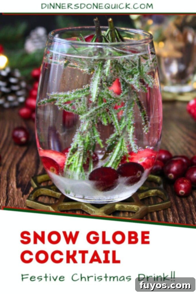 Snow Globe Cocktail recipe for Pinterest, featuring a festive drink surrounded by cranberries and rosemary.