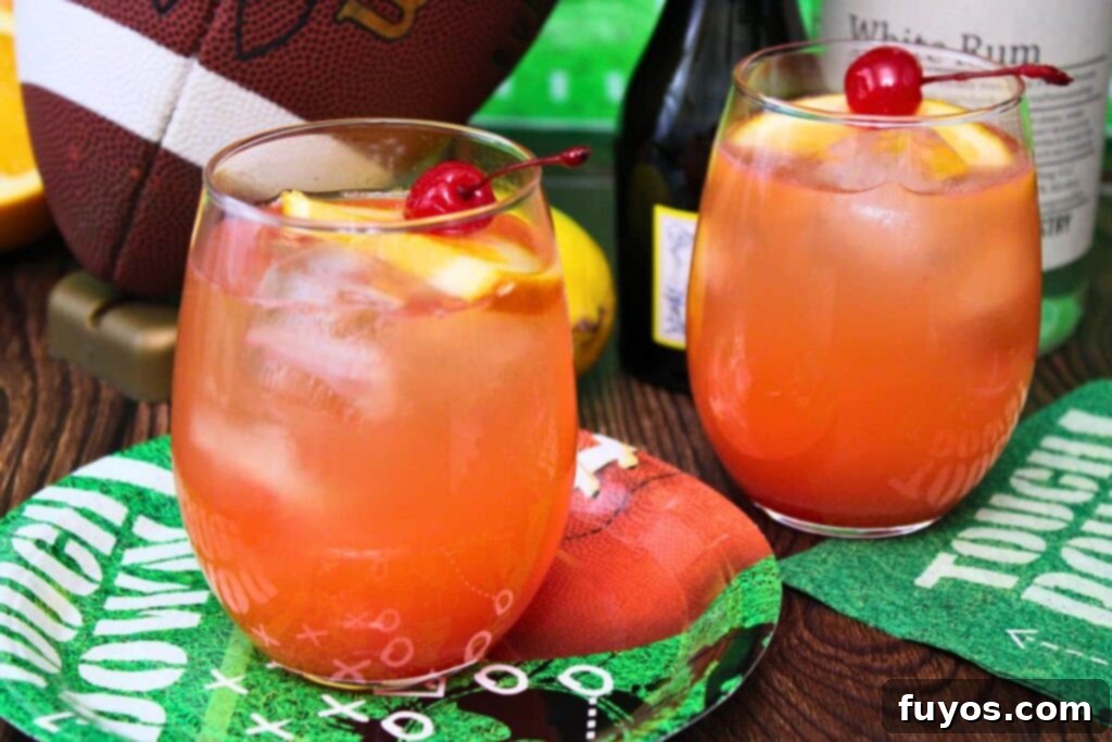 Simple Touchdown Thirst Quencher 9 closeup of two touchdown punch drinks in front of liquor bottles and a football