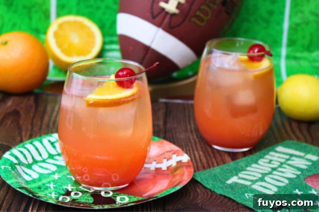 Simple Touchdown Thirst Quencher 3 two touchdown punch cocktails surrounded by football party supplies and a football