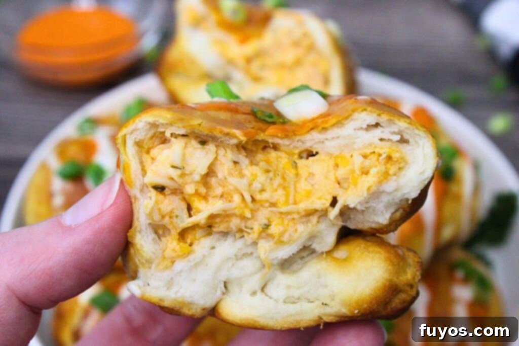 Game Day Air Fryer Buffalo Chicken Bombs 3 holding up half of a buffalo chicken bomb to show the inside