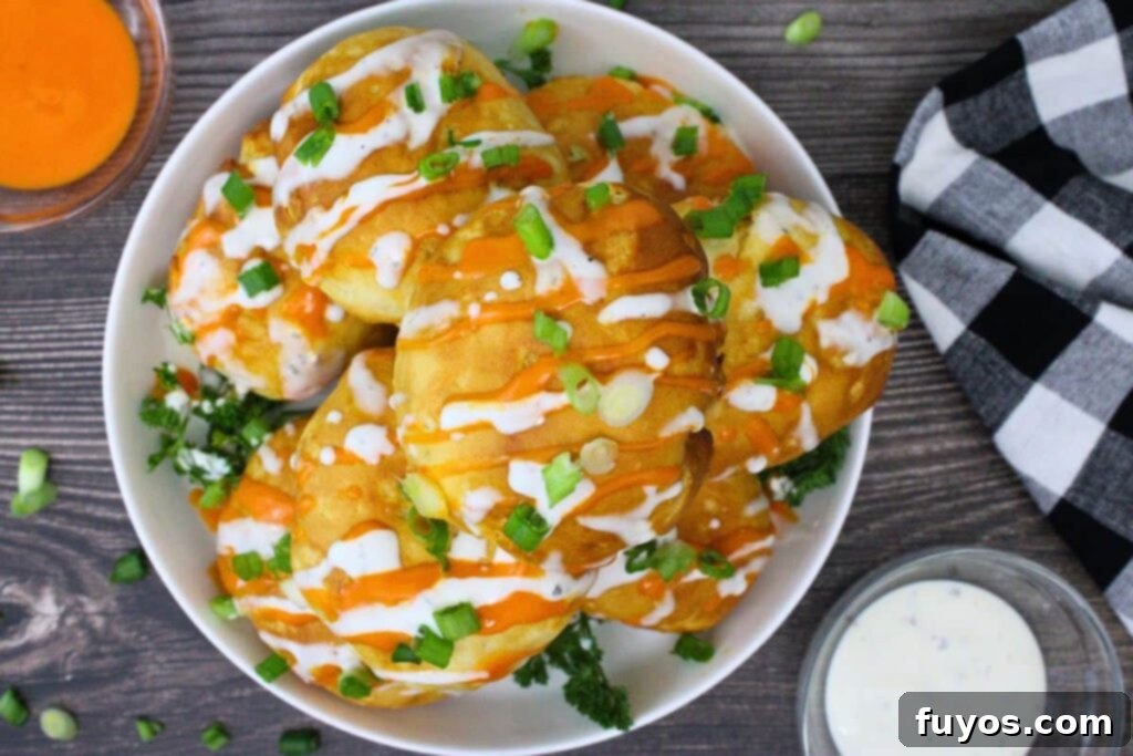 Game Day Air Fryer Buffalo Chicken Bombs 10 overhead view of air fryer buffalo chicken bombs on a plate drizzled with buffalo sauce and ranch