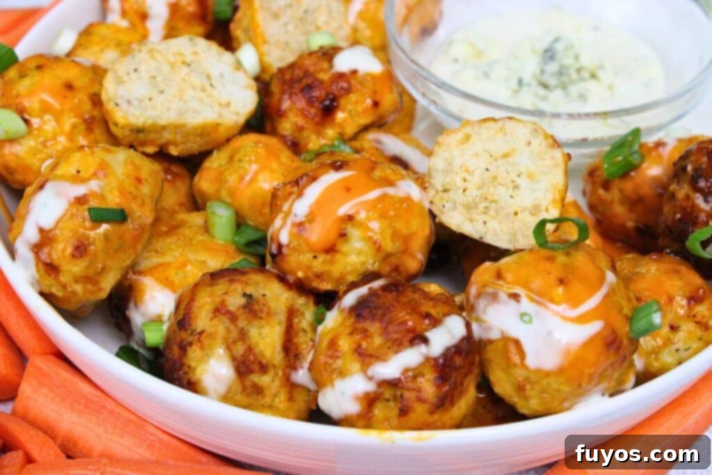 Air Fryer Buffalo Chicken Meatballs So Good So Simple 10 air fryer buffalo chicken meatballs on a plate with some cut in half drizzled in buffalo sauce and ranch