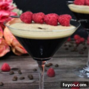 Chambord Raspberry Espresso Martini Made Easy 9 A Raspberry Espresso Martini, garnished with fresh raspberries and coffee beans, showcasing its frothy top and vibrant color, with a modern white border.