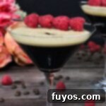 Chambord Raspberry Espresso Martini Made Easy 10 A Raspberry Espresso Martini, garnished with fresh raspberries and coffee beans, showcasing its frothy top and vibrant color, with a modern white border.