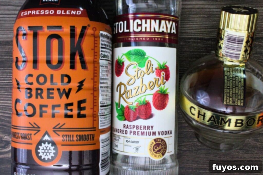 Chambord Raspberry Espresso Martini Made Easy 4 A selection of ingredients for the Raspberry Espresso Martini, including fresh raspberries, a bottle of vodka, a bottle of Chambord, and a shot of espresso, ready for mixing.