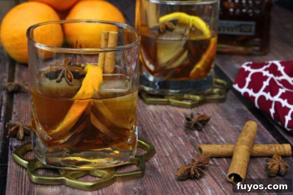 Chai Old Fashioned: The Warm Spice Bourbon 3 chai old fashioned on a gold coasted with orange peel, cinnamon sticks, and star anise