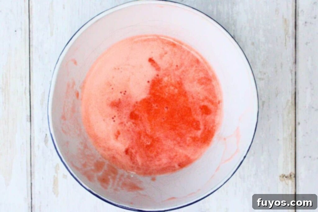 Step-by-step image showing strawberries, lemon juice, and simple syrup being added to a food processor, followed by straining the puree.