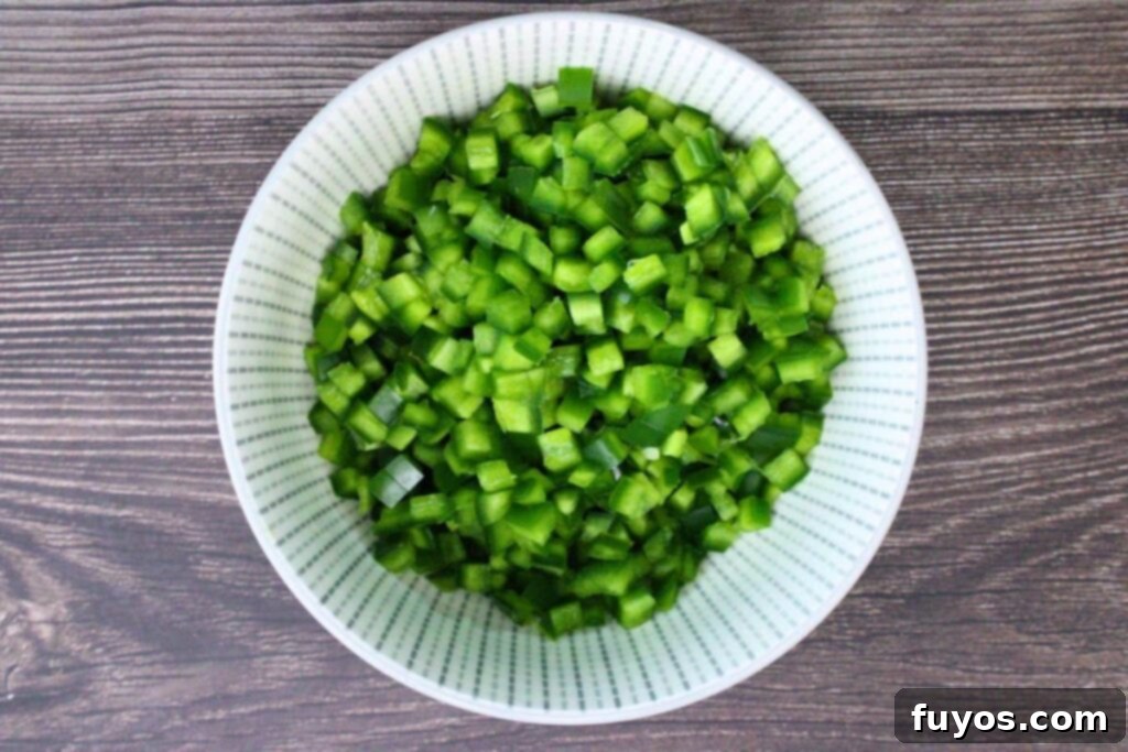 Close-up of diced jalapeno peppers with seeds removed, ready for the dip.