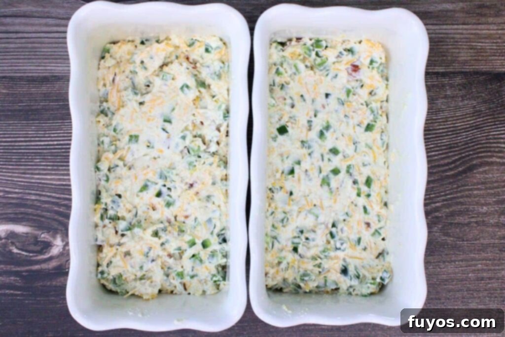 Jalapeno cream cheese mixture spread evenly into a baking dish, ready for the air fryer or oven.