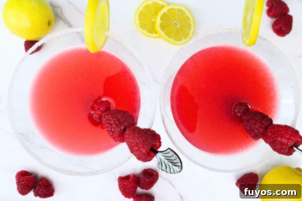 The Ultimate Homemade Raspberry Lemon Drop Cheesecake 9 overhead view of two raspberry lemon drop martinis garnished with raspberry skewers