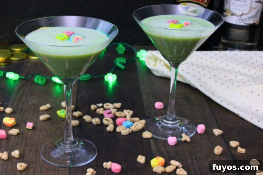St Patricks Day Lucky Charms Baileys Martini 9 Two Lucky Charms martinis elegantly presented on a wooden table, surrounded by scattered cereal marshmallows.