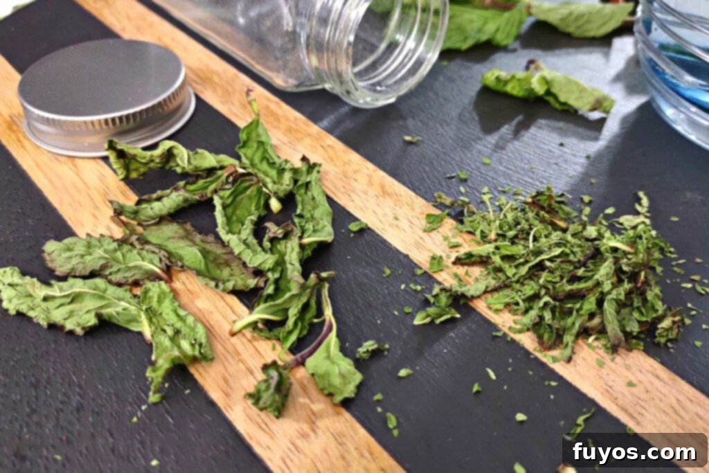 Dry Mint in Minutes: Microwave Method 9 Two piles of microwave-dried mint leaves, one whole and one crushed, for different culinary uses.