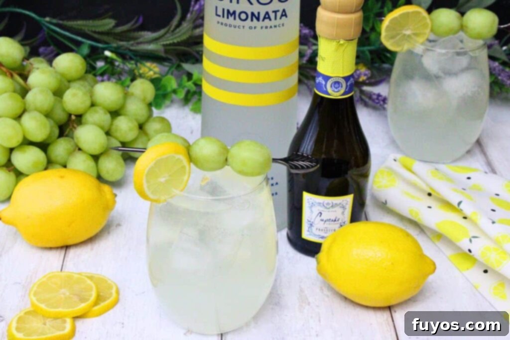 Zesty Sparkling Vodka Lemonade 3 Vodka lemonade spritzer garnished with fresh fruit, next to bottles of vodka and prosecco, surrounded by spring decor.